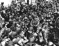 Normandy Invasion, June 1944 Army troops on board a LCT, ready to ride across the English Channel to France. Some of these men wear 101st Airborne Division insignia. Photograph released 12 June 1944. Official U.S. Navy Photograph, National Archives.
